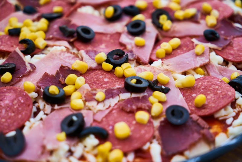 Chef hand-stretching fresh pizza dough in Pizza Ranch kitchen