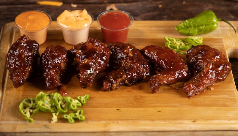 Meat lovers pizza piled with pepperoni, sausage, bacon, and ham